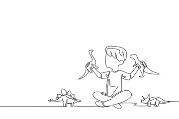 Single one line drawing a boy plays with a dinosaur toy on the floor with each hand holds a toy. Collection of extinct animal toys. Exciting. Dinosaur Day. Continuous line design graphic illustration