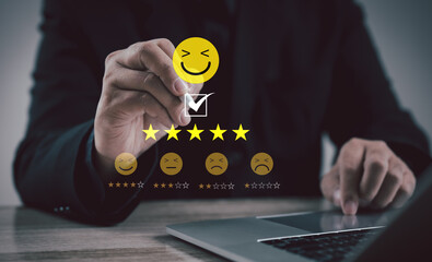 Professional selecting five-star rating with smiling emoji on digital interface, representing customer satisfaction, feedback, service review, quality assurance, and business reputation.