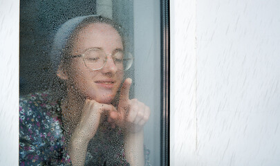 Young girl at the old window