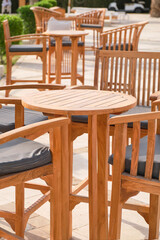 Bar on a beach with bar chairs, circle table and blurred background. Outdoor. Shallow depth of field.