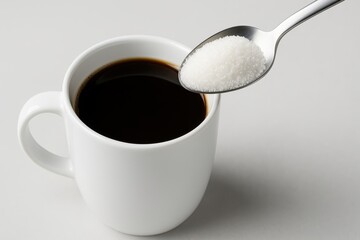 Pouring sugar into coffee cup home kitchen beverage scene simple setting close-up daily ritual