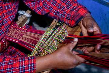 The weaving hands of a woman from the village of Tupe, laborious craftsmanship, with great patience and creativity, bring the fabrics to life. Tupe, Yauyos, Perú.