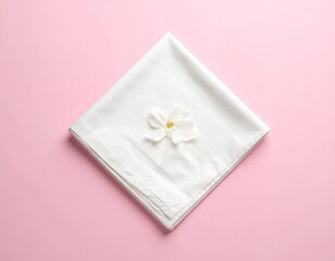 lat lay of a folded napkin corner, soft pastel background.