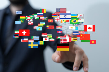 A hand touching digital flags represents global communication, international relations, and...
