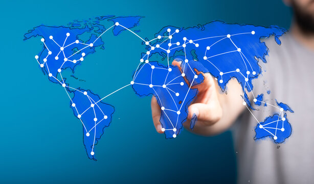 A human hand interacts with a digital world map, illustrating global connectivity, business networks, and technological advancement.