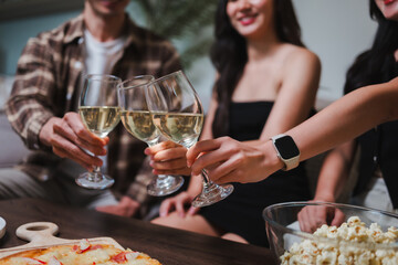 Friends toasting with wine glasses celebrating successful moment