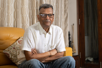 Fototapeta premium Indian eyewear elder man sitting at home relaxing at home