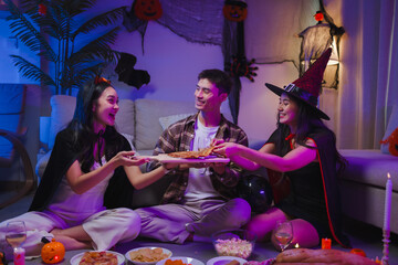 Friends wearing costumes enjoying Halloween party together