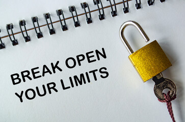 BREAK OPEN YOUR LIMITS text, Motivational notepad with yellow padlock and key symbolizing breaking...