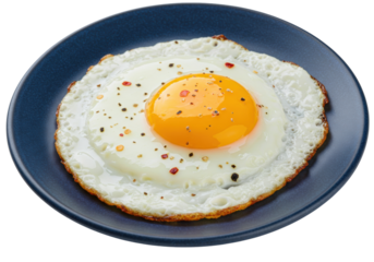 Isolated fried egg on a blue plate, garnished with salt, pepper and chili flakes meal prep food