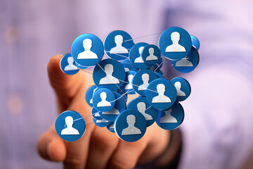 Close up of a hand interacting with a network of interconnected people icons. Social connections and communication in digital world concept.