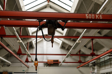 High-angle view of an industrial crane system inside a factory warehouse.