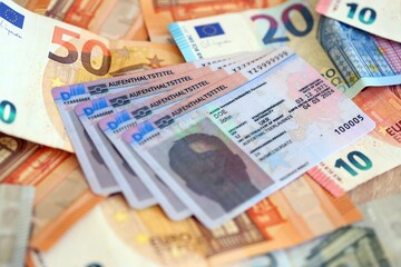German Permanent resident card with euro money bills. Aufenthaltstitel