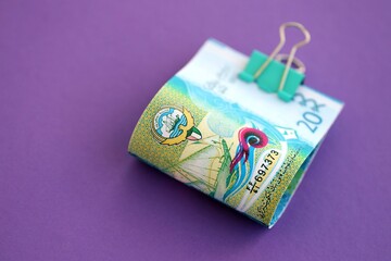 Kuwaiti dinar money bills in big amount on purple. Finance and banking concept