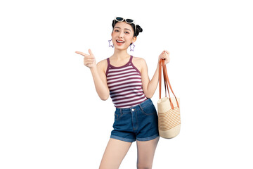 Smiling young woman holding a beach bag, pointing and enjoying the summer sun on PNG