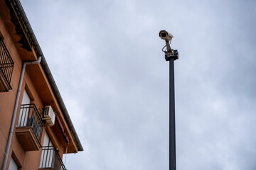 Fototapeta premium CCTV camera with blurred building and blue sky background.