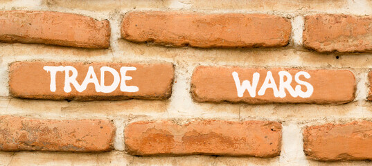 Trade wars symbol. Concept word Trade wars on beautiful old brown brick wall. Beautiful old brown...