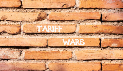 Trade tariff wars symbol. Concept word Tariff wars on beautiful old brown brick wall. Beautiful old...