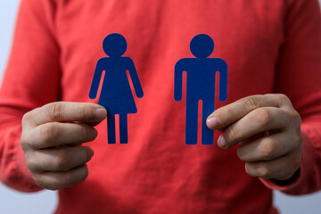 Person holding male and female gender symbols, representing inclusivity, relationships, and...