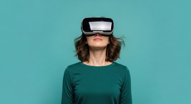 Young caucasian female wearing vr headset against teal background - Powered by Adobe