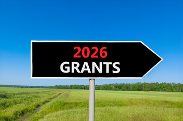 2026 Grants symbol. Concept words 2026 Grants on beautiful black road sign. Beautiful green grass field forest and blue sky background. Business and 2026 grants concept. Copy space.