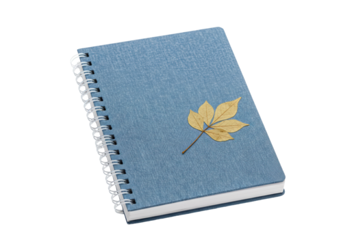 Blue spiral notebook with a yellow leaf isolated, stationery for writing and drawing on a blank page