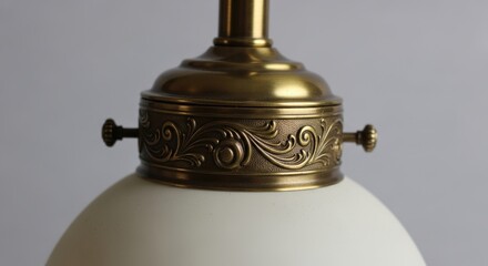 Elegant brass light fixture with intricate design and white glass shade