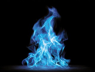 Fototapeta premium Brilliant blue flame against a stark black background, with wisps and a central core