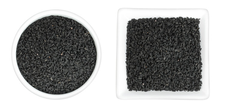 Nigella sativa or Black cumin in ceramic bowl isolated on white background. Top view. Flat lay.