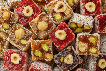 The sweet confectionery cubes are filled with pistachios and hazelnuts. Some pieces are dusted with coconut creating a delicious texture.