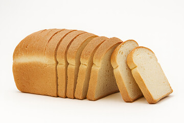 Several uniform slices are cut from the fresh loaf. This staple food is a common ingredient for sandwiches and toast in many homes.