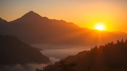 Mountain sunrise casting golden light over misty valleys in a serene morning landscape.