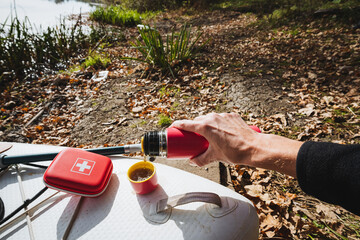 Experience the joy of sipping on a warm beverage while surrounded by the beautiful landscape of nature by the water. An adventure that captures the essence of cozy moments in the outdoors