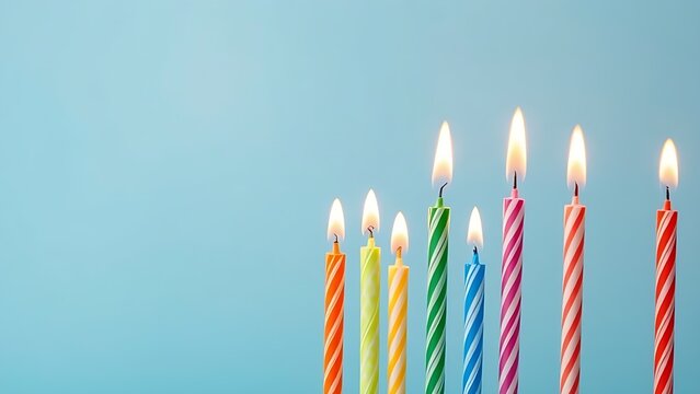 Colorful birthday candles with glowing flames, creating a festive and celebratory atmosphere.
