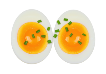 Two halved boiled eggs isolated, garnished with fresh chives on a clean background