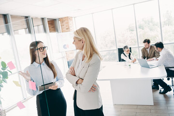 Professional team in a modern office discussing ideas and collaborating for a business presentation with technology