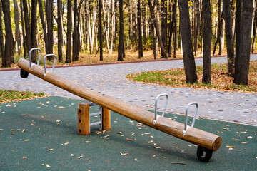 Explore the Outdoor Wooden SeeSaw Playground Equipment in a serene forest, designed for kids to improve balance, engage in teamwork, and have fun during exciting, educational playtime activities
