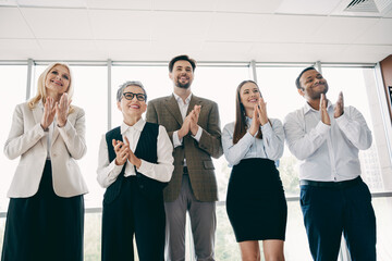 Professional Business Team Collaborating in Modern Office Setting with Clapping Pose and Positive Energy