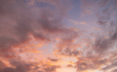 Awesome sunset and soft pink clouds of pastel tones. Image template of textured sky. Gorgeous photo wallpaper. Bright epic sky. Dramatic evening light and fiery orange sunset. Beauty of earth.