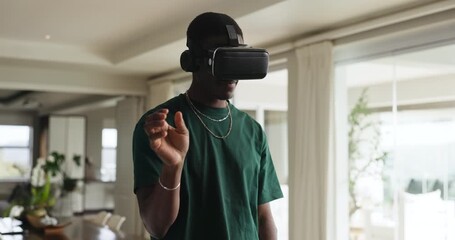 African, man and headphones in home with VR headset, hand gestures and navigation for virtual reality. Technology, person and digital in house with movement, gaming and equipment for 3D experience. - Powered by Adobe