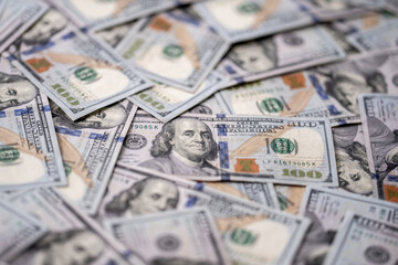 Money background with 100-dollar bills. Texture of US money currency. 100 USD banknotes in focus. American hundred-dollar money. Pattern of US dollars. Money for finance concept.