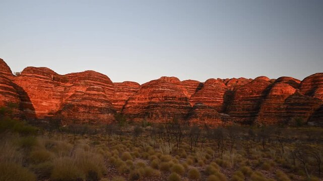sunset over Purnululu National Park, World Heritage Site in the kimberley region of Western Australia, a popular travel destination famous for its layered rock formations, of the Bungle Bungle Range.
