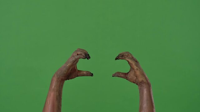 Creepy zombie hands make a heart sign
