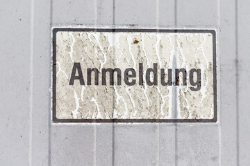 Sign with German word "Anmeldung" on corrugated surface