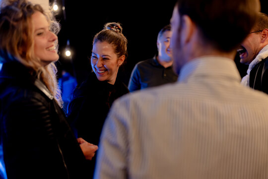 A Group of Friends Smiling and Enjoying a Cheerful Conversation in a Relaxed Environment