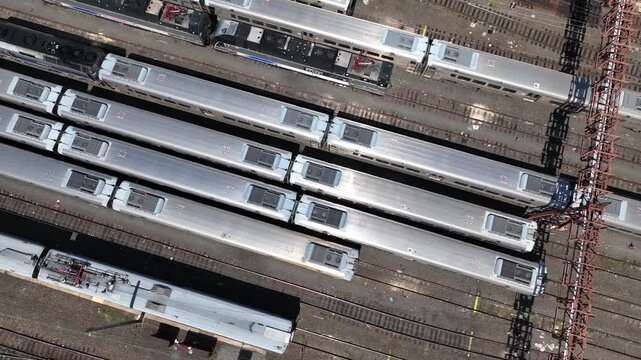 Hoboken Transit Station rail yard on New Jersey shore across from New York City skyline. Sunshine shimmering on  transit cars on tracks below