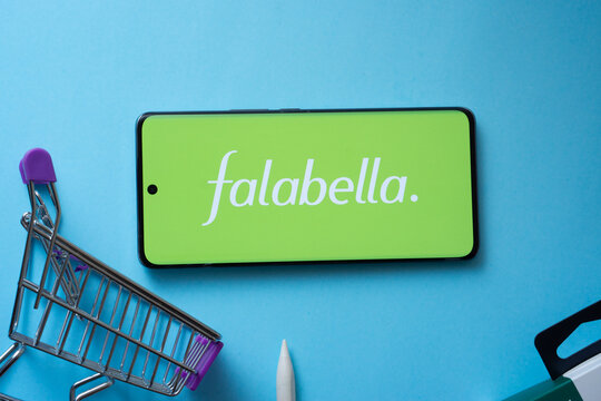 Dhaka, Bangladesh- 03 Oct 2025: Smartphone displaying Falabella. logo with shopping cart on a blue background.