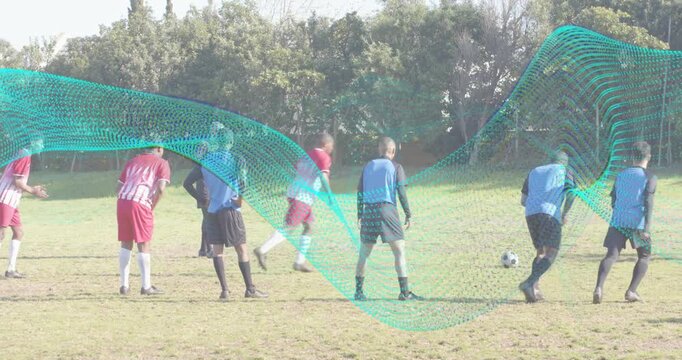 Blue-team kicker placing soccer ball and running up, striking free kick over wall to score goal