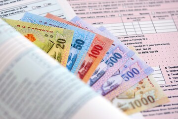 Thai baht money bills on tax form. Taxation and accounting concept