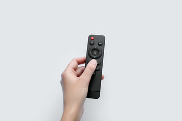 Hand turns on the light with the remote control
